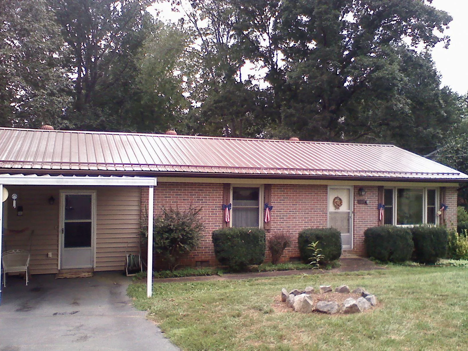 Bronze metal roof and carport on a brick ranch home — Roof Repair work by our crew in Indian Springs