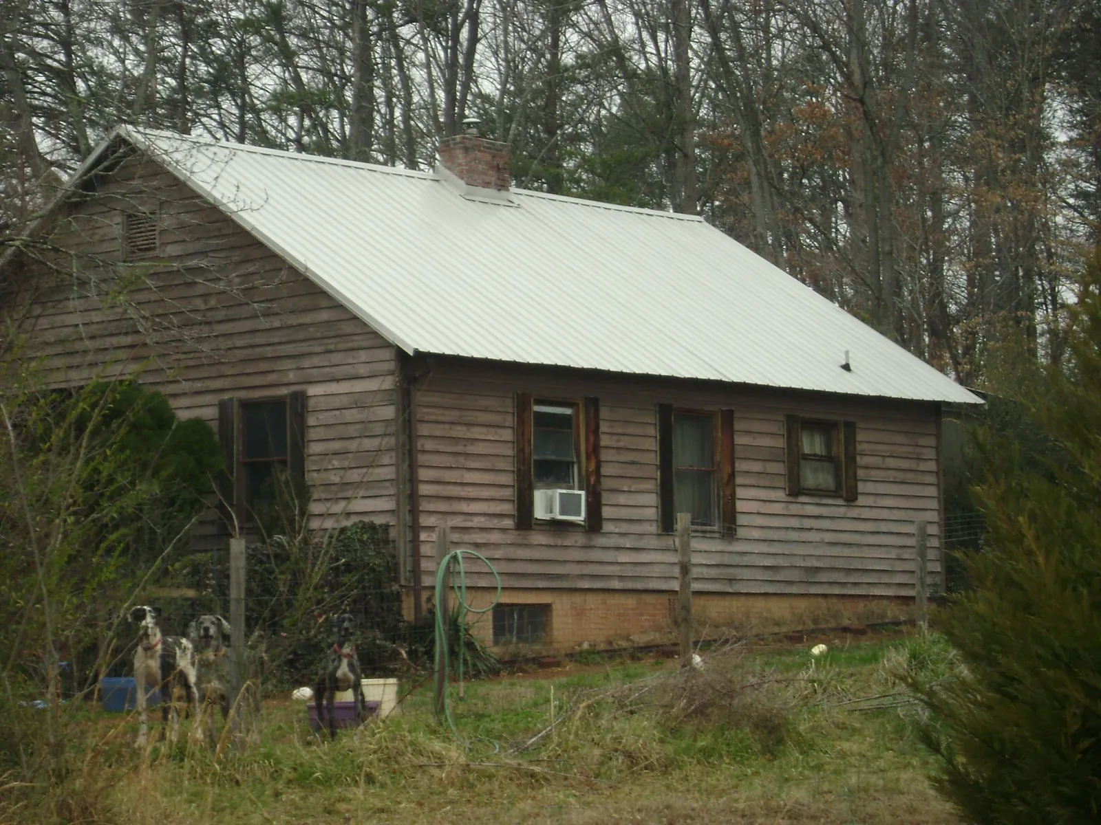 White metal roof on an old wood sided farmhouse, from a Metal Roof Installation job in Indian Springs